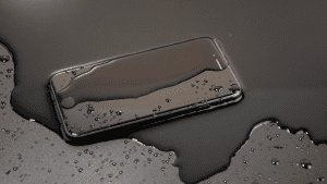 Phone on table covered in water