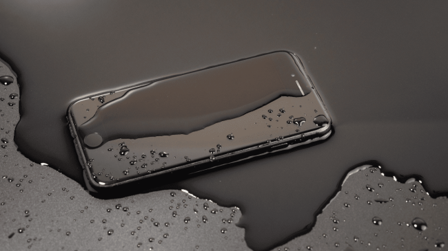 Untitled design-94 Phone on table covered in water